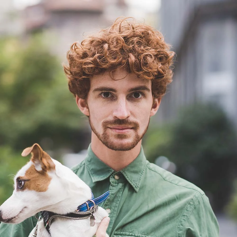 Man holding a dog in his hand